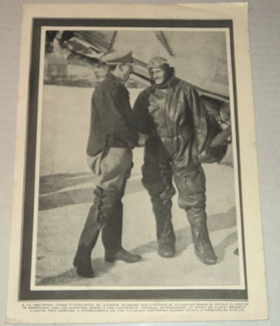 Image for A vintage magazine photographic illustration of the IRISH AVIATOR PIONEER JAMES FITZMAURICE, who flew on the first East to West Trans-Atlantic flight, shaking the hand of American aviator FLOYD BENNETT, Byrd's pilot during his expedition to the North Pole who also flew the relief mission to the Bremen aviators.