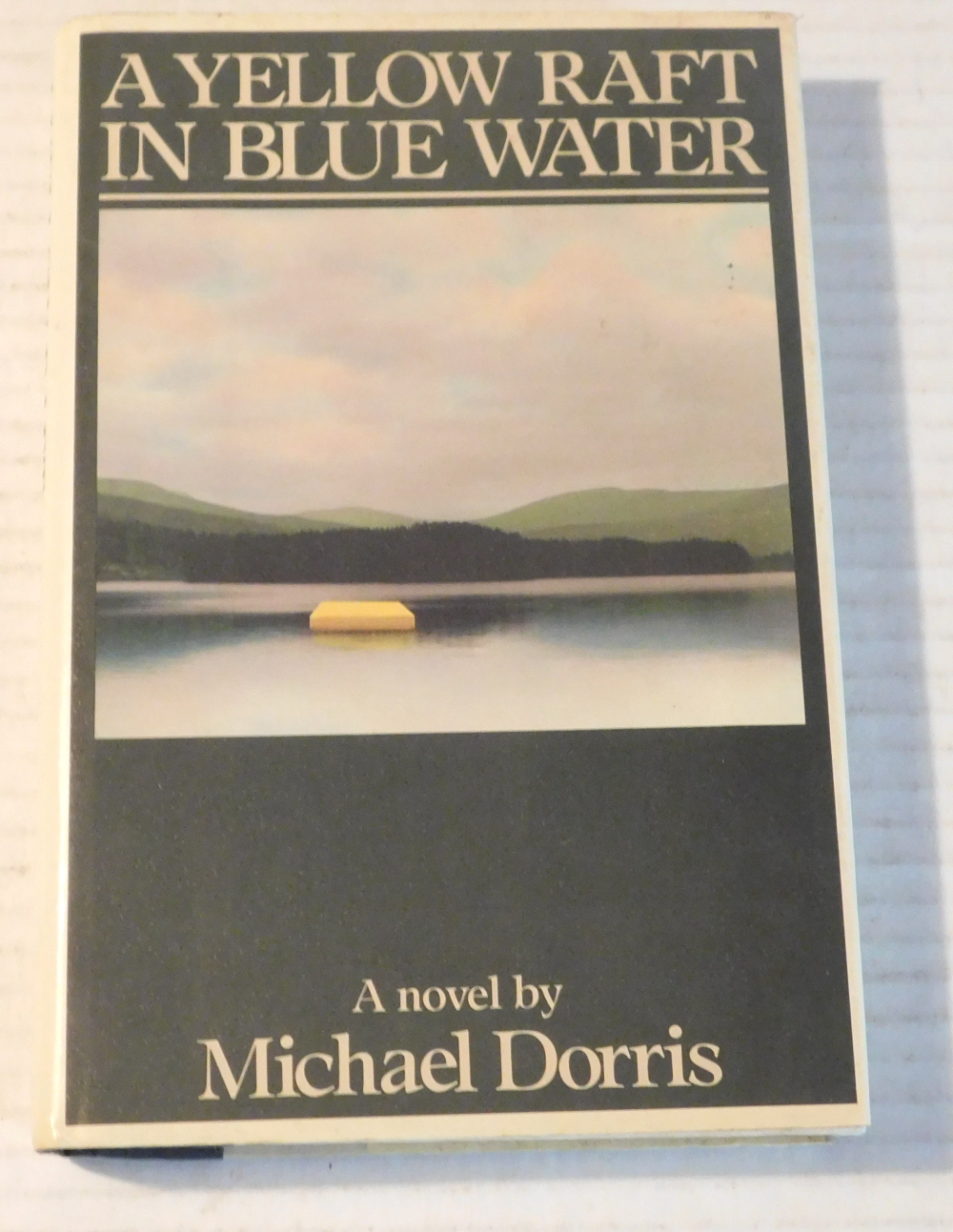A YELLOW RAFT IN BLUE WATER. [SIGNED by MICHAEL DORRIS].